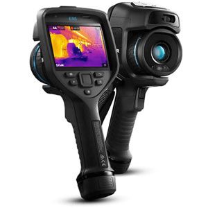 Thermal imaging camera scanning a wall for hidden moisture.